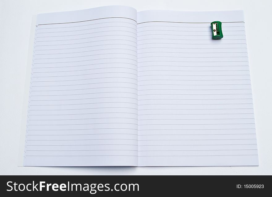 Opening book and pencil Sharpener on white background.