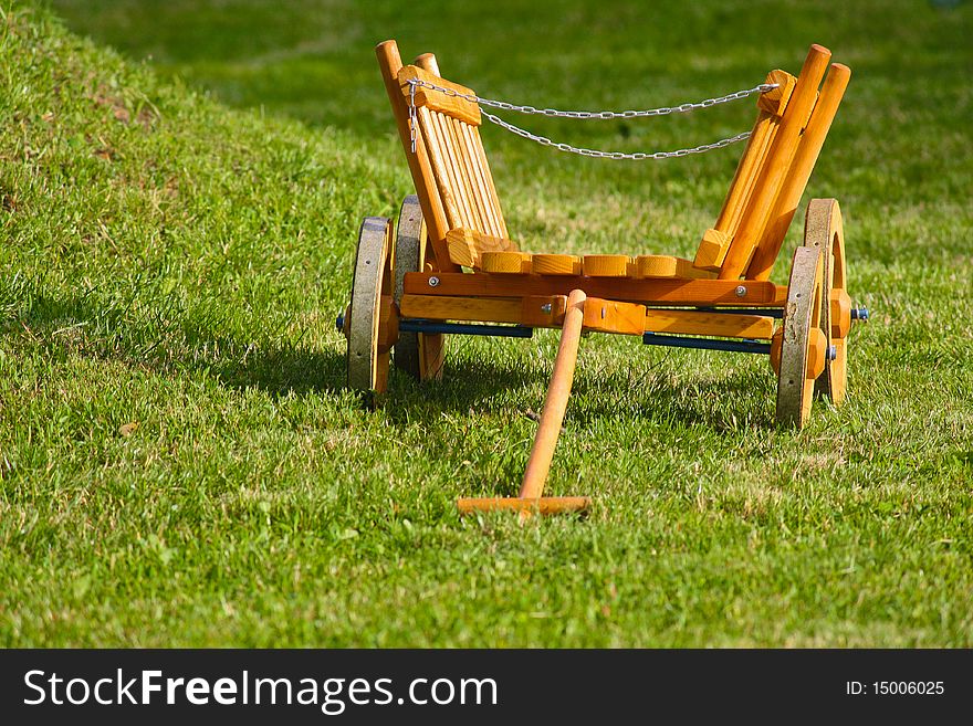 Wooden toy cart in the grass