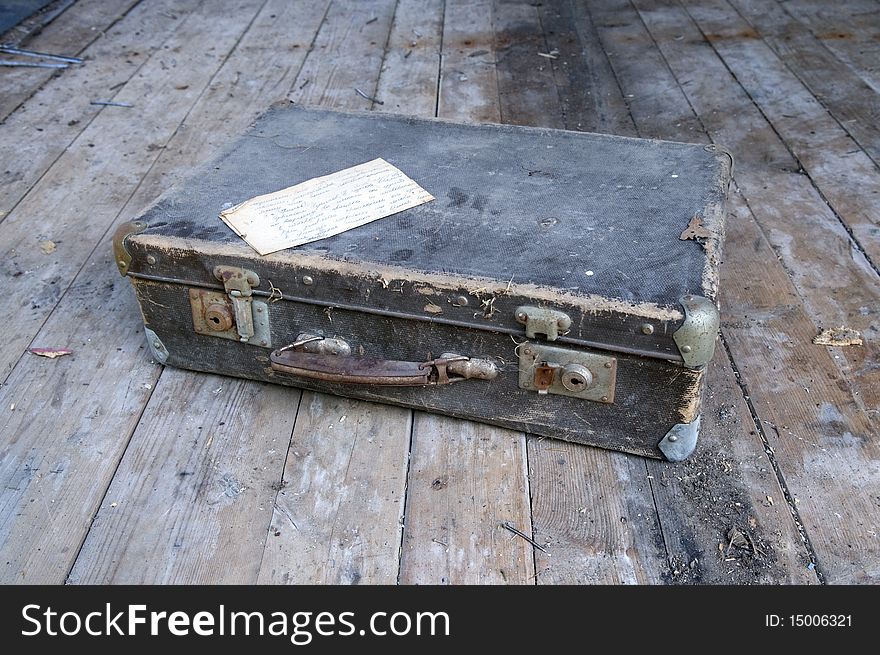 Ancient suitcase on board to a floor.
