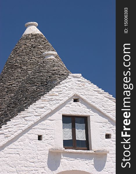 Trulli roof against vivid blue sky