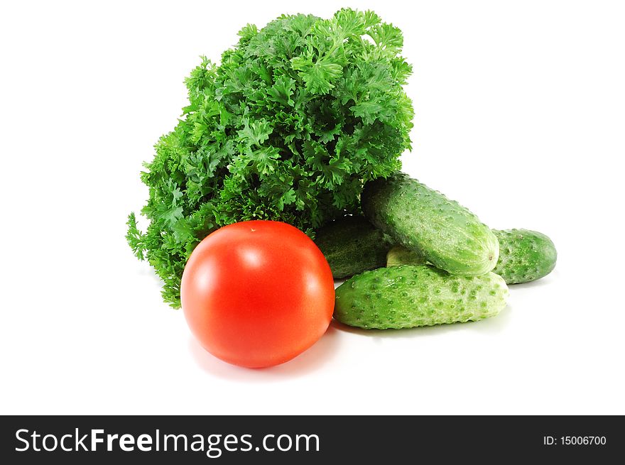 Fresh vegetables with parsley foliage are isolated on a white background