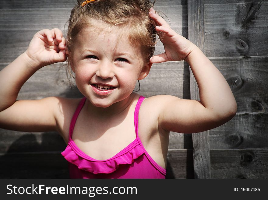 Happy girl in pink swimming suite