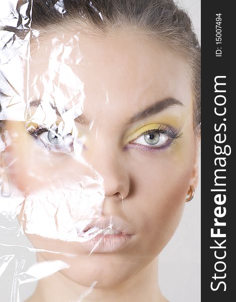Female Face Wrapped In Cellophane