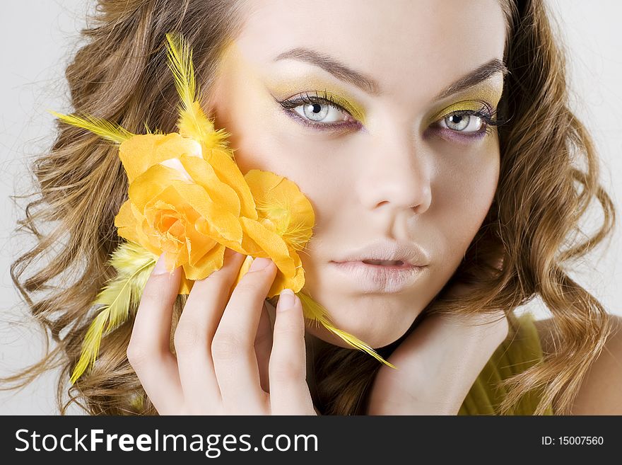 Fashion model posing with rose in her hands. Fashion model posing with rose in her hands.