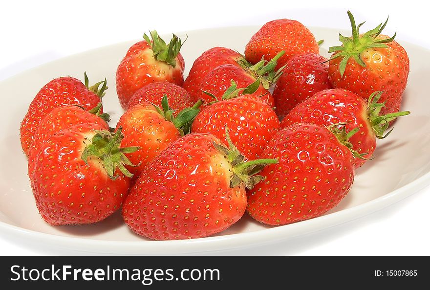 A close up shot of strawberries on a plate. A close up shot of strawberries on a plate.