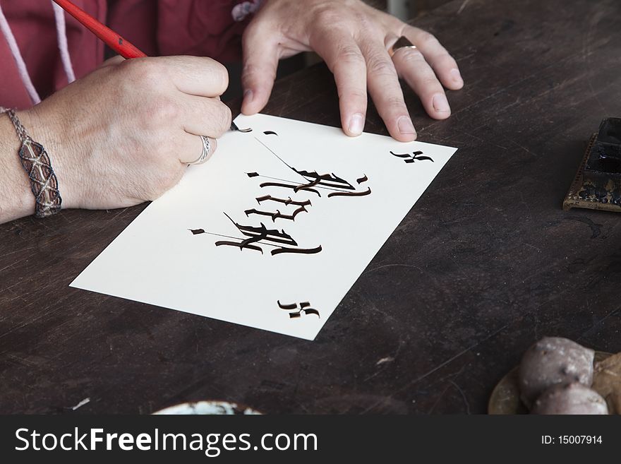 Calligrapher's hands making a gothic-letter ink pen crafts and old-fashioned. Calligrapher's hands making a gothic-letter ink pen crafts and old-fashioned