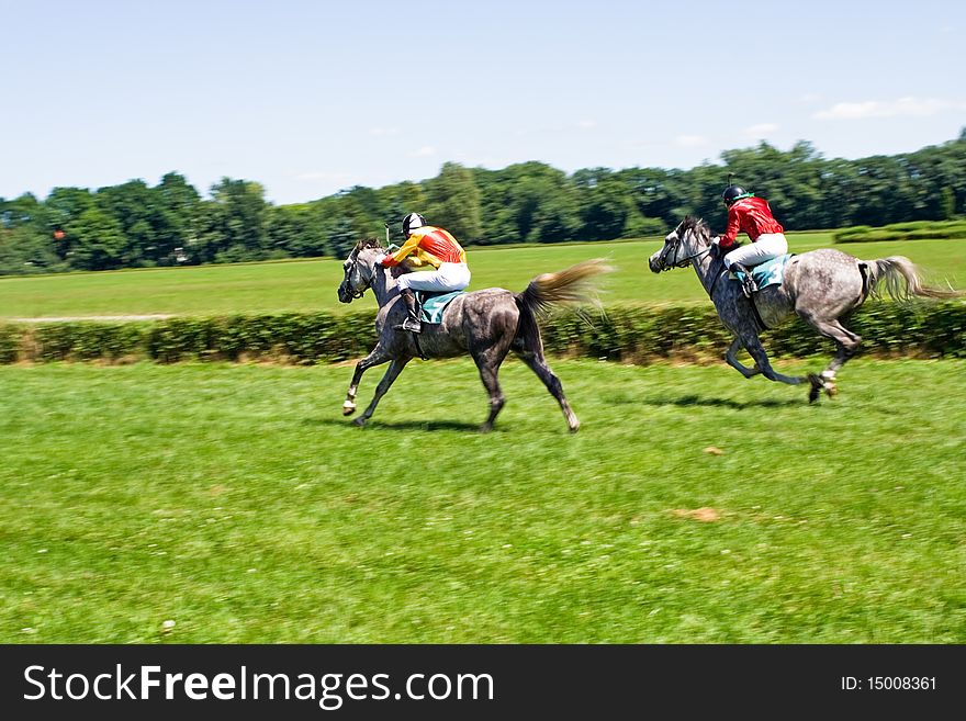 Horse racing on green racecourse, motion blur. Horse racing on green racecourse, motion blur