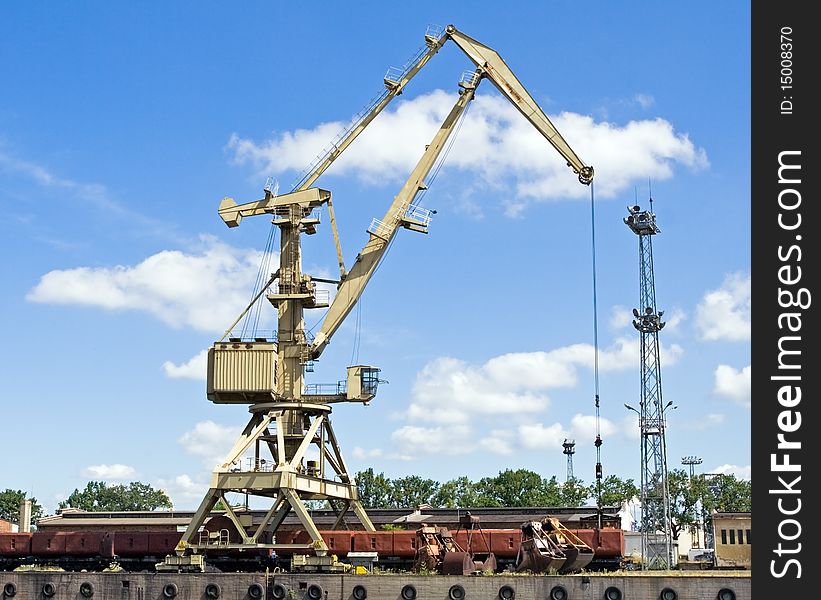 Crane At Loading Dock Over Blye Sky