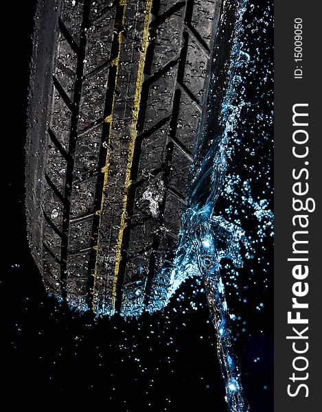 Tire with water drops on it black background