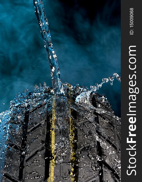 Tire with water drops on it smoke background