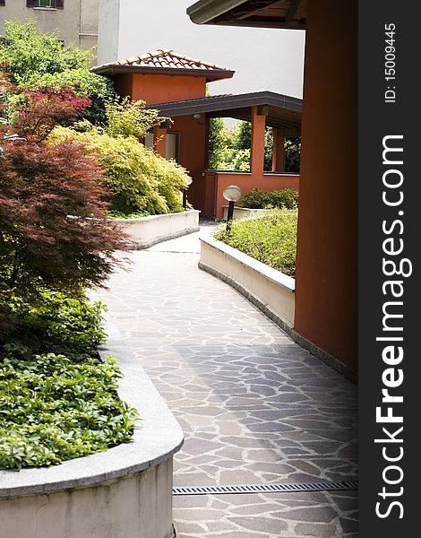 Entrance of a building with beds full of plants. Entrance of a building with beds full of plants