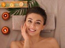 Happy Young Woman Relaxing In Spa Salon Royalty Free Stock Image