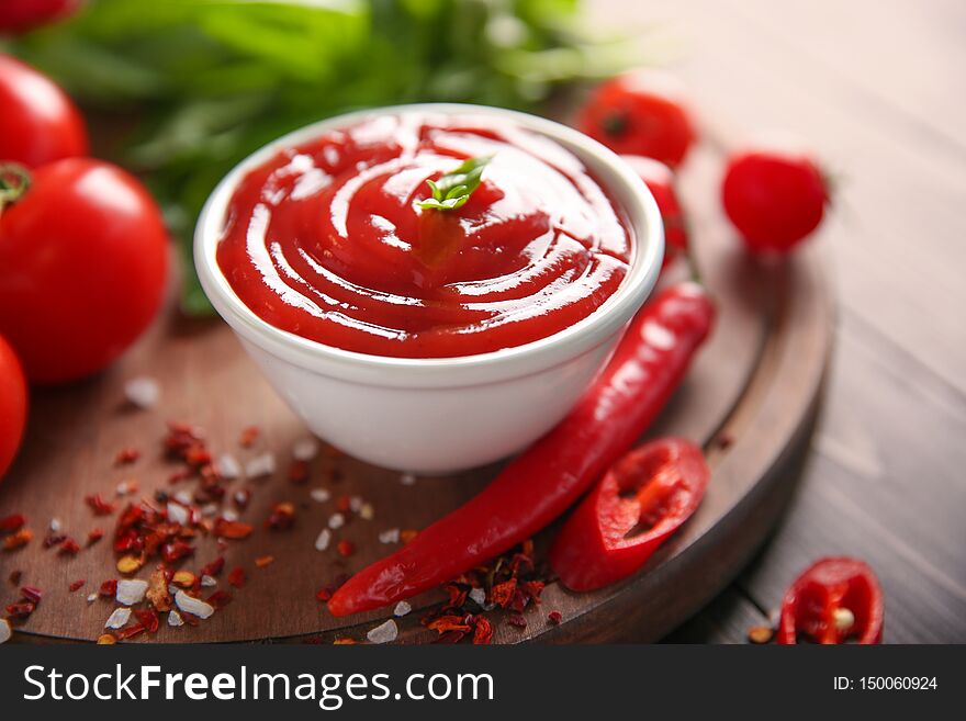 Bowl With Red Sauce And Vegetables On Table