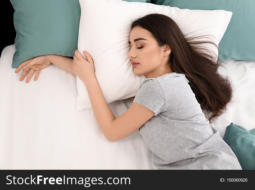 Young beautiful woman sleeping in morning at home