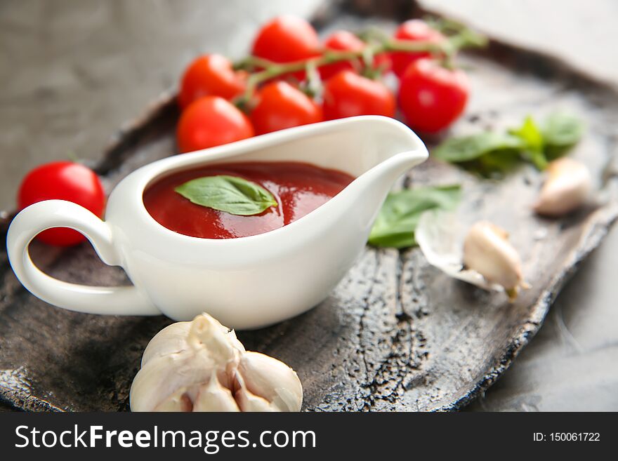 Gravy Boat With Red Sauce And Vegetables On Plate