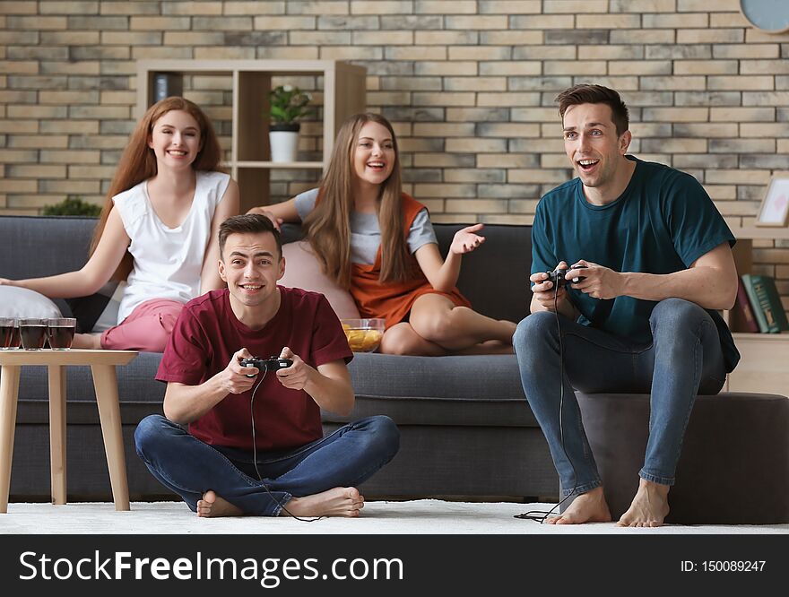 Young People Playing Video Games At Home