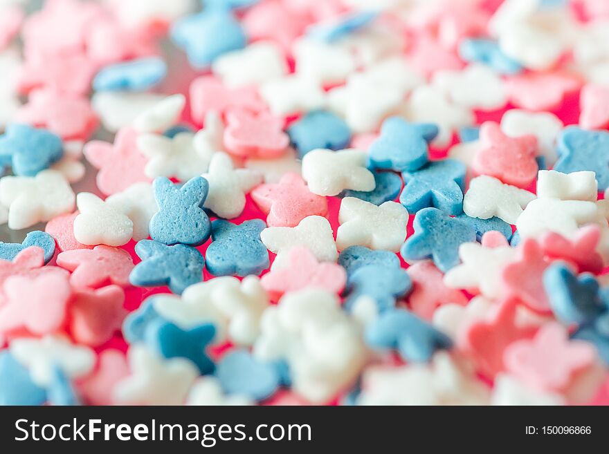 Multicolored candy on a pink background