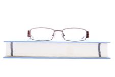 Eyeglasses On The Blue Book Royalty Free Stock Photography