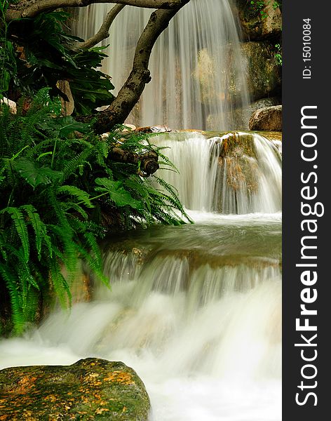 This image is a natural waterfall and surrounding foliage. This image is a natural waterfall and surrounding foliage.