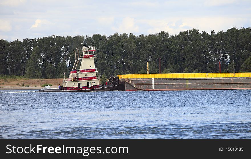 A push boat and a barge moving on the Columbia river Oregon. A push boat and a barge moving on the Columbia river Oregon.