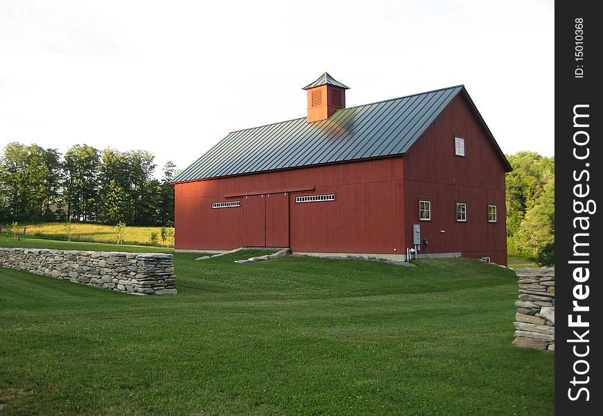 A red barn on a knoll in the Vermont makes 
a peaceful setting as the sun is going down. A red barn on a knoll in the Vermont makes 
a peaceful setting as the sun is going down