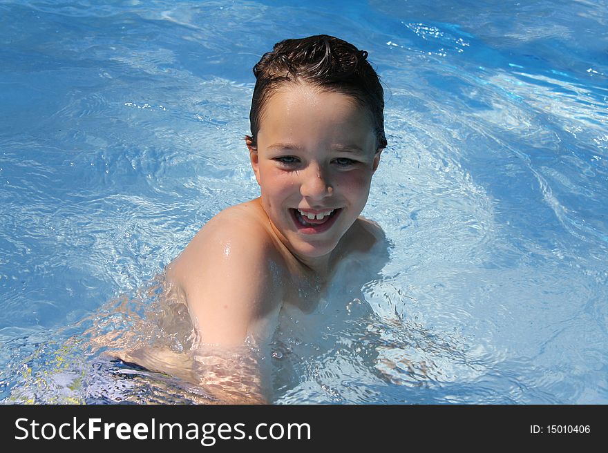 Happy boy playing in a pool. Happy boy playing in a pool.