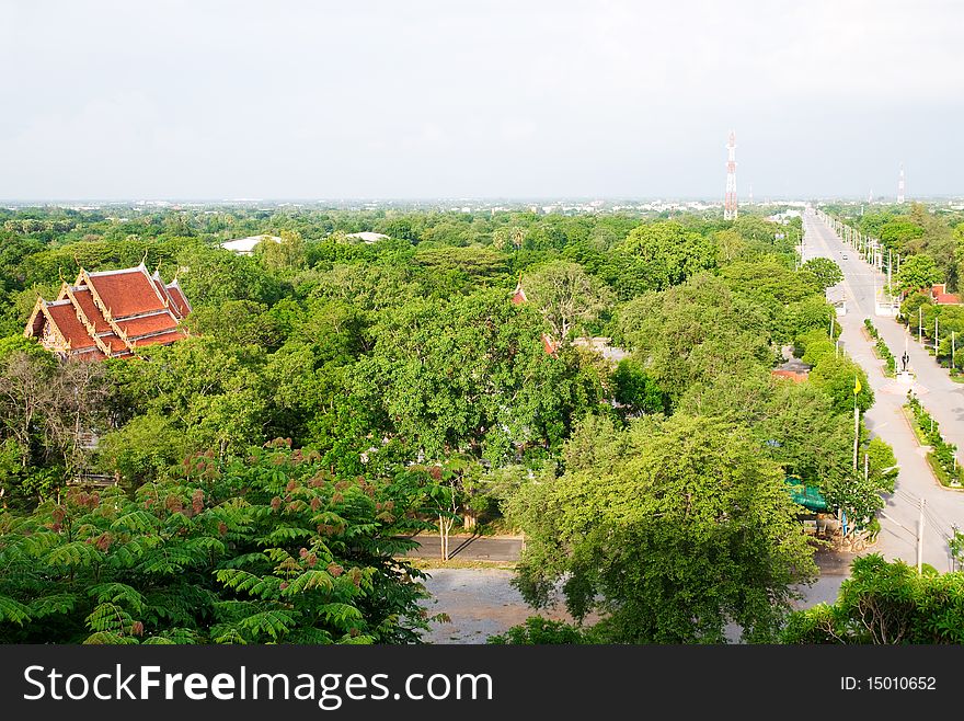 Flat, featureless landscape, typical for the Central Plains of Thailand. The photo shows the town of U Thong in Suphanburi province. There's a temple in the foreground and a mobile phone antenna pylon in the background. Flat, featureless landscape, typical for the Central Plains of Thailand. The photo shows the town of U Thong in Suphanburi province. There's a temple in the foreground and a mobile phone antenna pylon in the background.