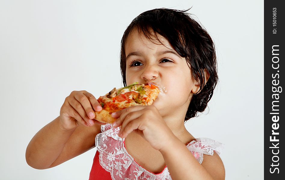 Sweet and pretty toddler posing for camera and eating pizza slice. Sweet and pretty toddler posing for camera and eating pizza slice