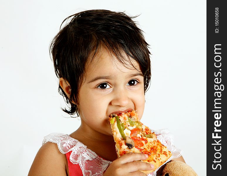 Sweet and pretty toddler posing for camera and eating pizza slice. Sweet and pretty toddler posing for camera and eating pizza slice