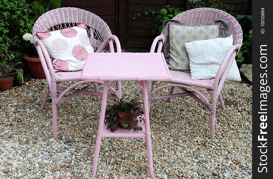 A shingled patio area with chairs for relaxing in the garden. A shingled patio area with chairs for relaxing in the garden