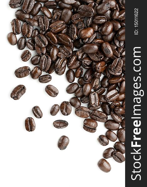 Coffee beans on white background. Heap out from upper right edge for border design element. Coffee beans on white background. Heap out from upper right edge for border design element