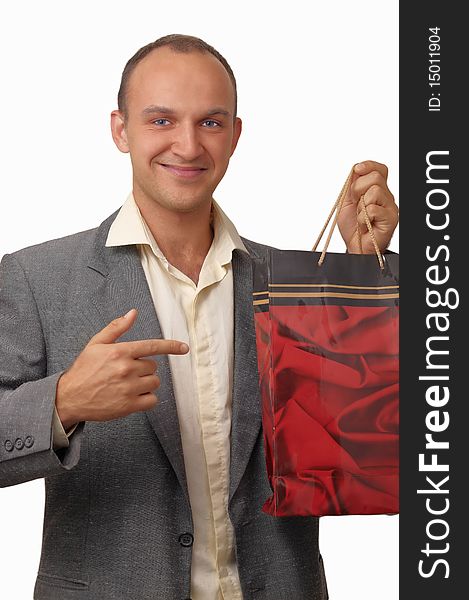 A young man wearing a jacket with a gift bags . A young man wearing a jacket with a gift bags .