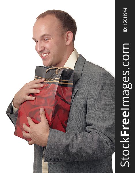 A young man wearing a jacket with a gift bags . A young man wearing a jacket with a gift bags .