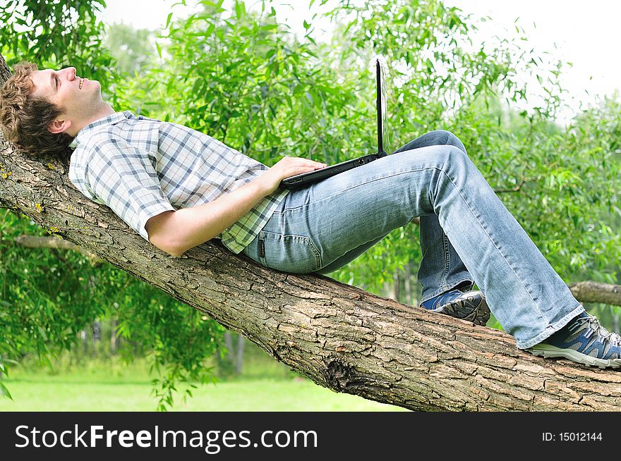 Guy with a laptop on the tree