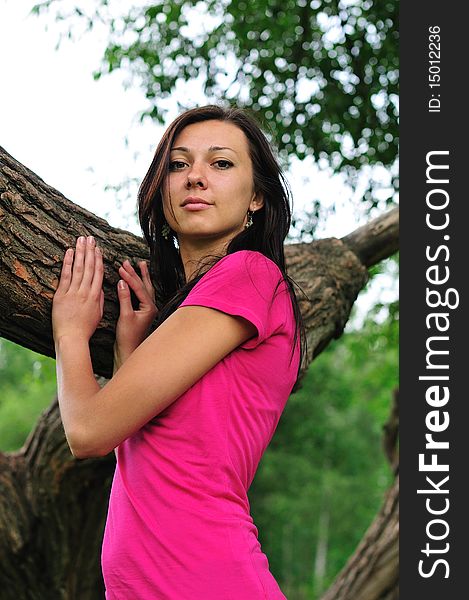 Young woman standing near the big tree. Young woman standing near the big tree