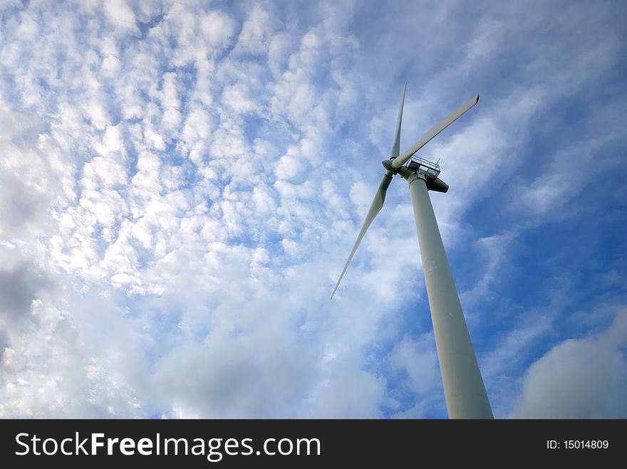 Wind turbines have a sky blue background