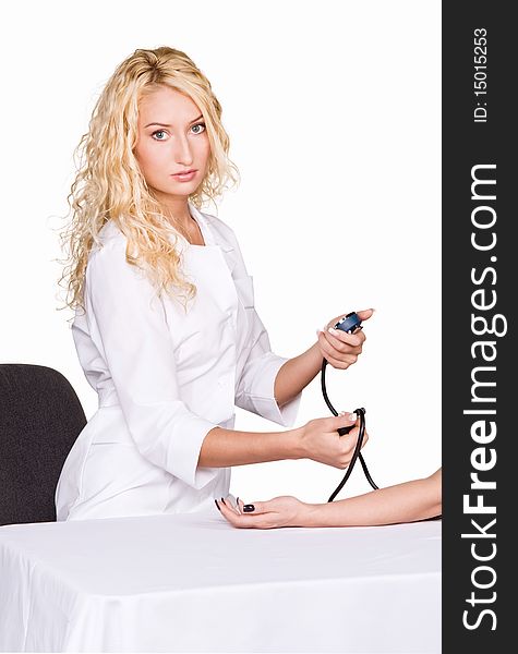 Young female doctor taking blood pressure on white