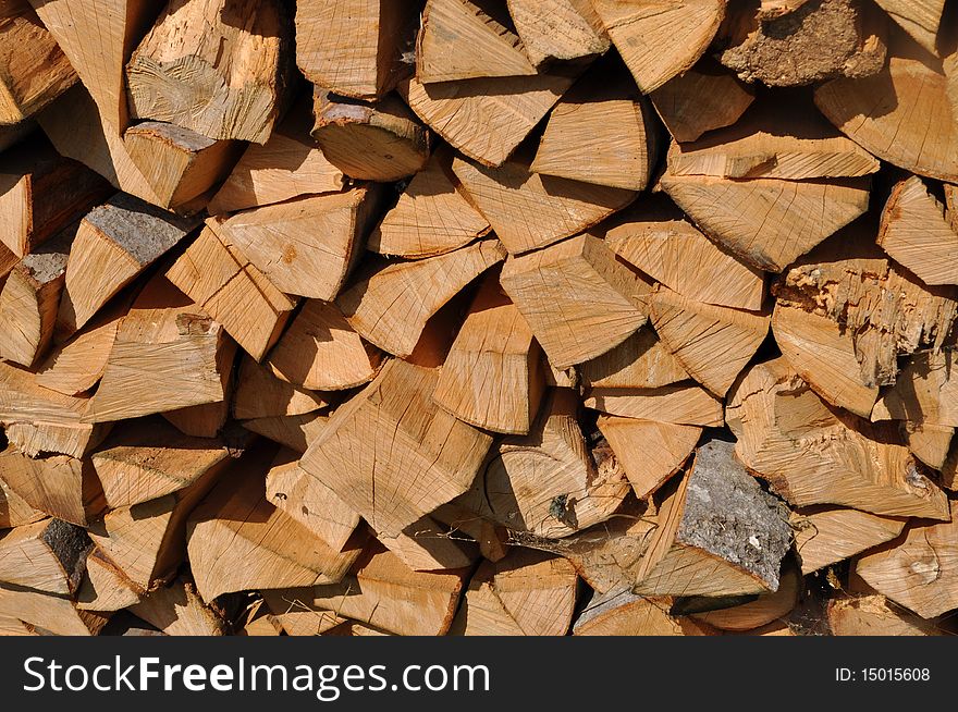 A wall of a wooden shed with accurately laid fire wood for heating. A wall of a wooden shed with accurately laid fire wood for heating.