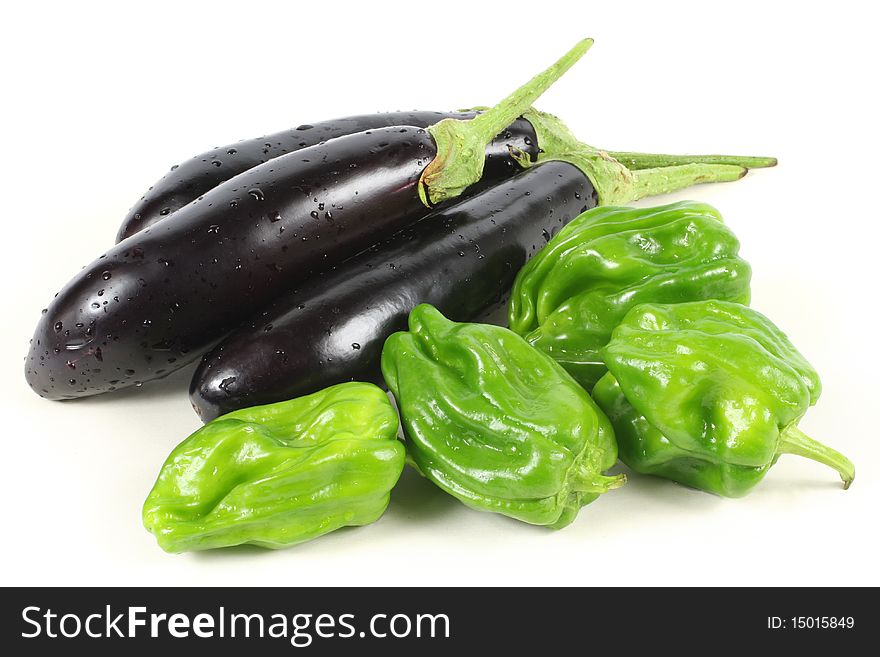 Eggplant and pepper on a white background. Eggplant and pepper on a white background