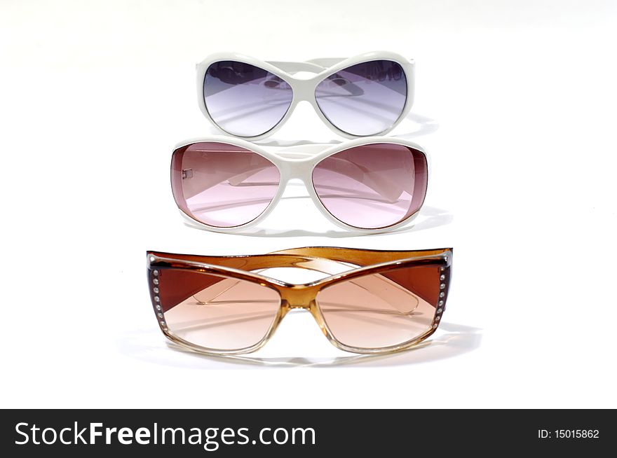 Row of fashion sunglasses on white. Row of fashion sunglasses on white