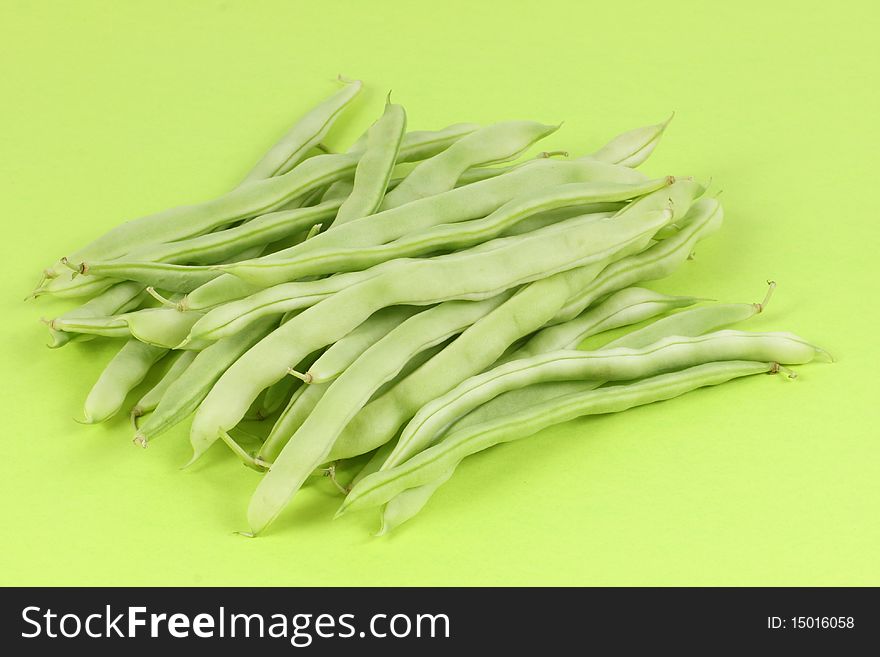 Green beans isolated on green background