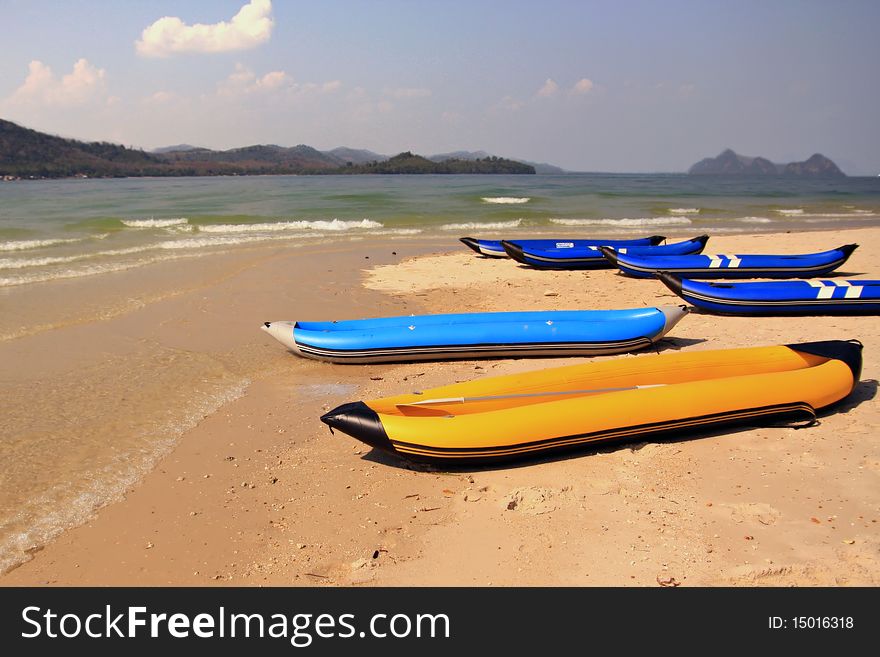 Yellow and blue inflatable boats for entertainment, ashore sea. Yellow and blue inflatable boats for entertainment, ashore sea.