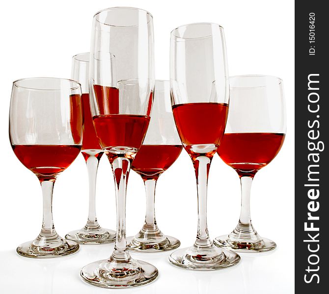 Six wine glasses of various sizes and various fills of red wine on white. Six wine glasses of various sizes and various fills of red wine on white