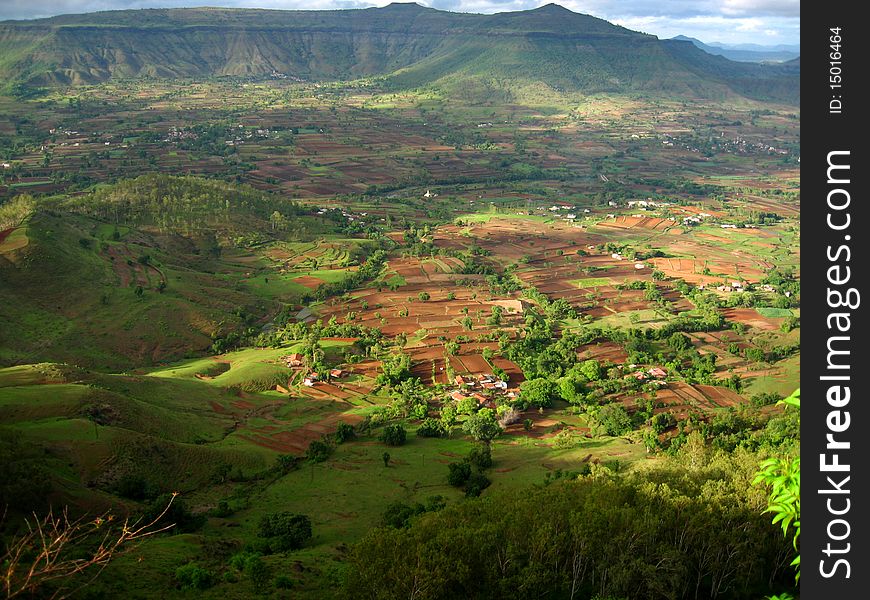 An exotic scene of an Indian farm landscape with distant mountain ranges. An exotic scene of an Indian farm landscape with distant mountain ranges.