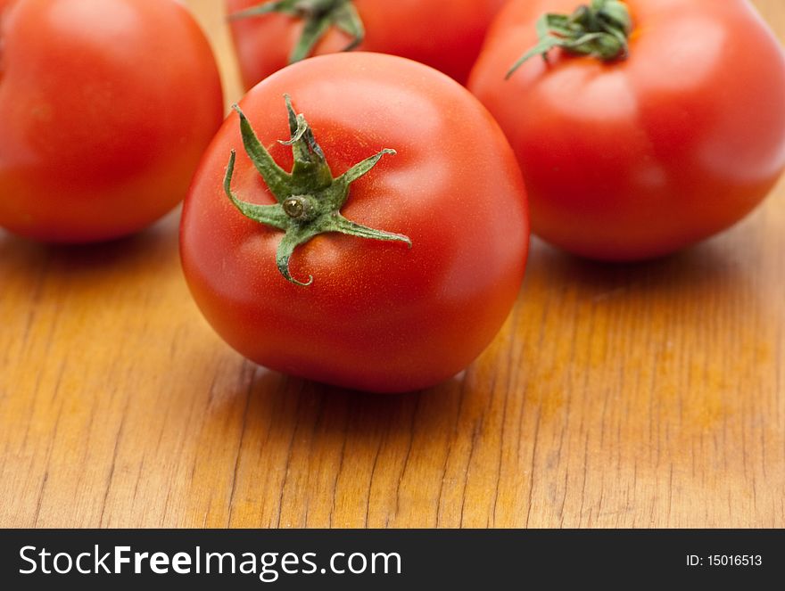 Tomatoes on the wood background