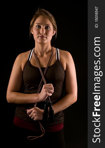 Beautiful fit young woman posing with jump rope. Beautiful fit young woman posing with jump rope