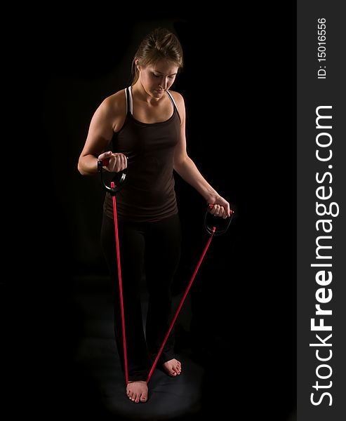 Attractive young athlete working out with rubber tubing. Attractive young athlete working out with rubber tubing