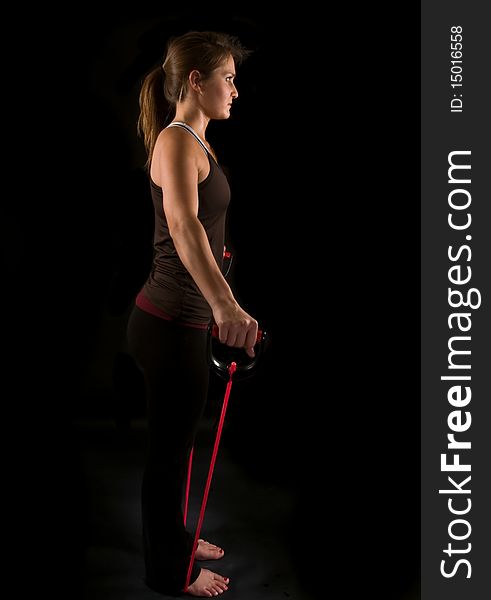 Attractive young athlete working out with rubber tubing. Attractive young athlete working out with rubber tubing