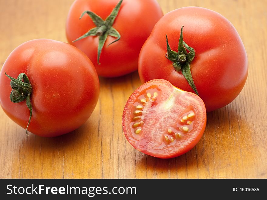 Fresh tomatoes on a wood background.