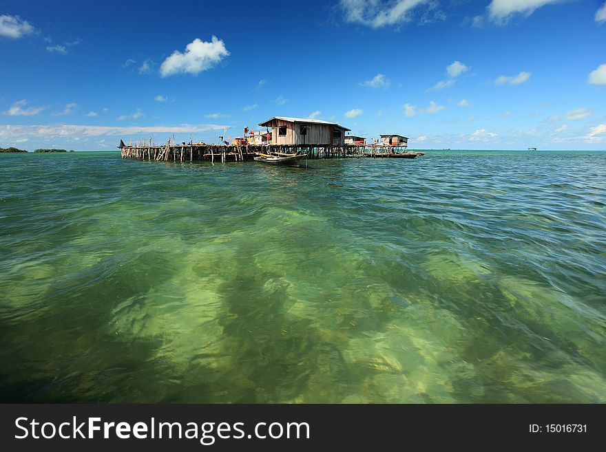 Water Village with deep blue sky, clouds and crystal clear water.